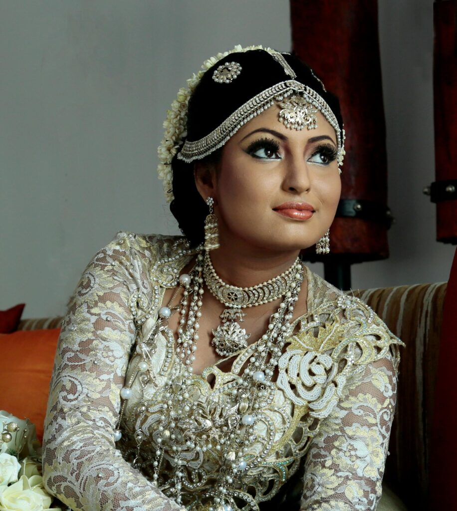 Stunning portrait of a South Asian bride wearing intricate jewelry and traditional gown.